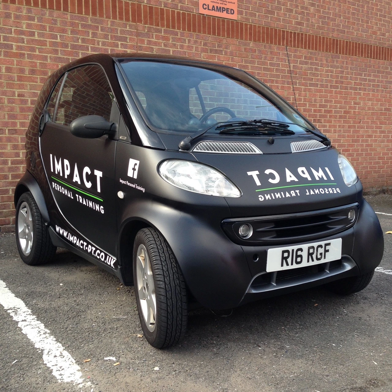 Front three-quarter view of the Impact Smart car with mirrored bonnet lettering